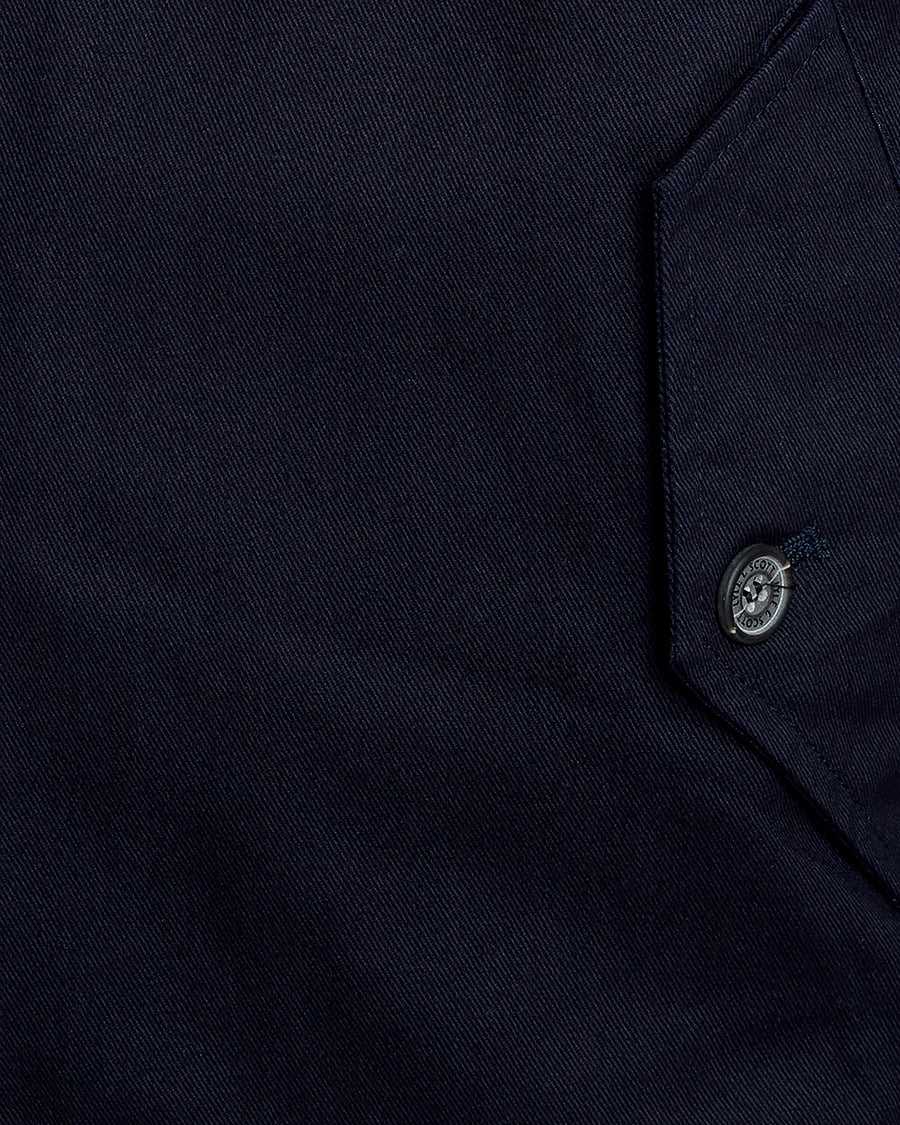 Man wears Cotton Harrington Jacket in Dark Navy