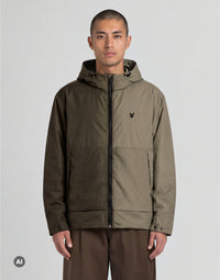 Man wears Heat Reactive Shell Jacket in Washed Brown / Cove