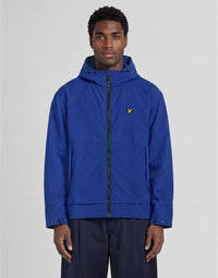 Man wears Water Reactive Shell Jacket in Blue Purple