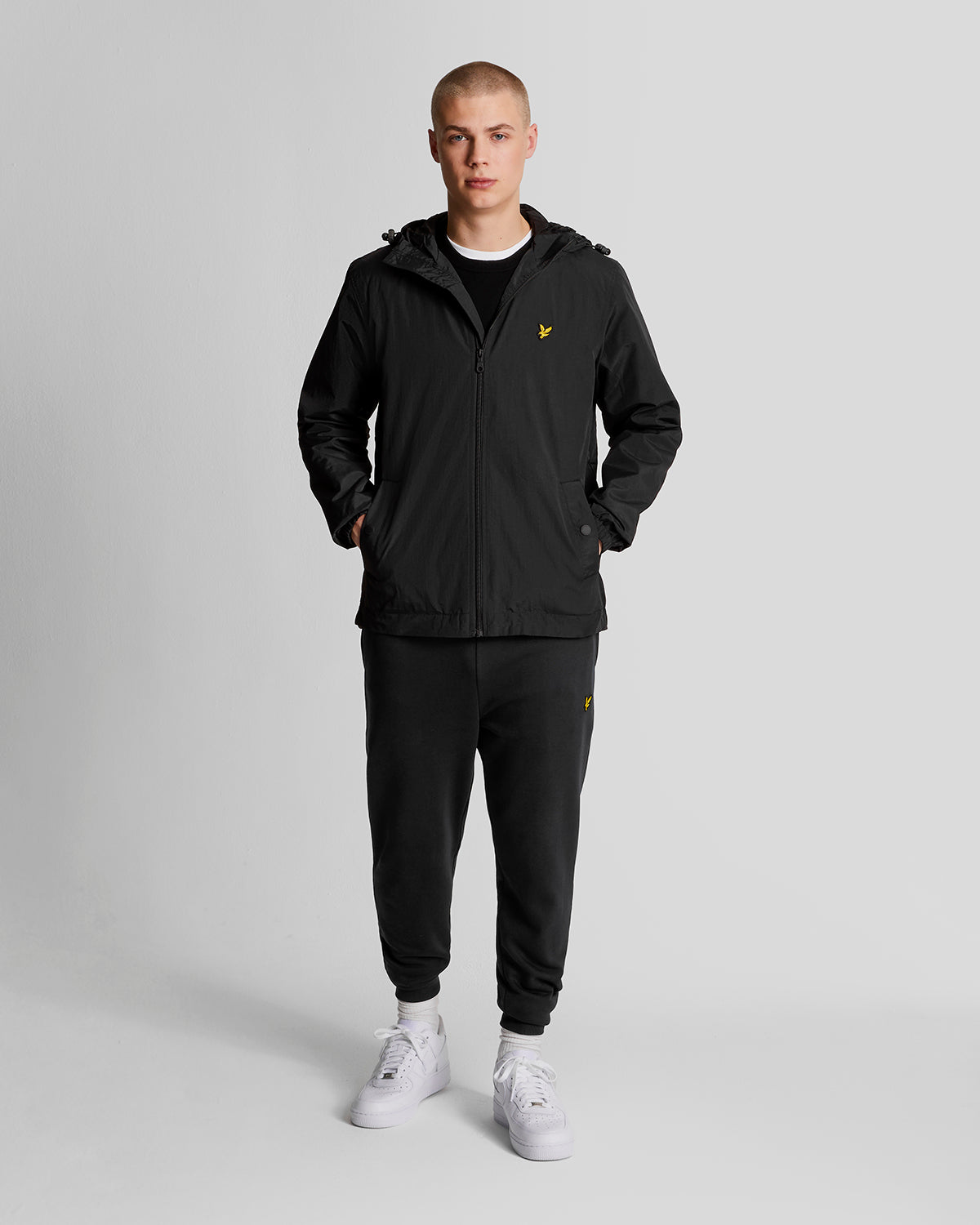 Man wears Water Resistant Hooded Jacket in Jet Black