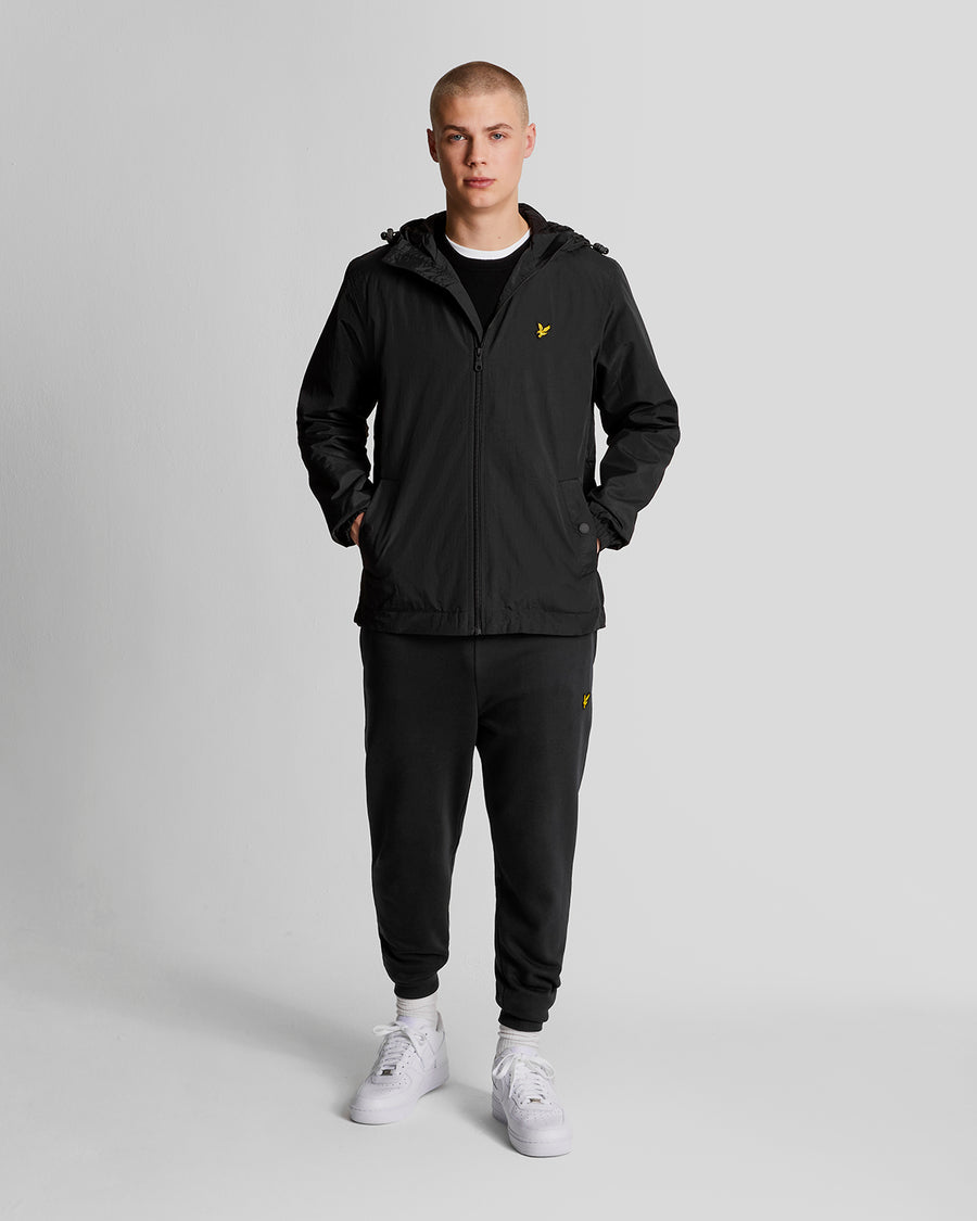 Man wears Water Resistant Hooded Jacket in Jet Black