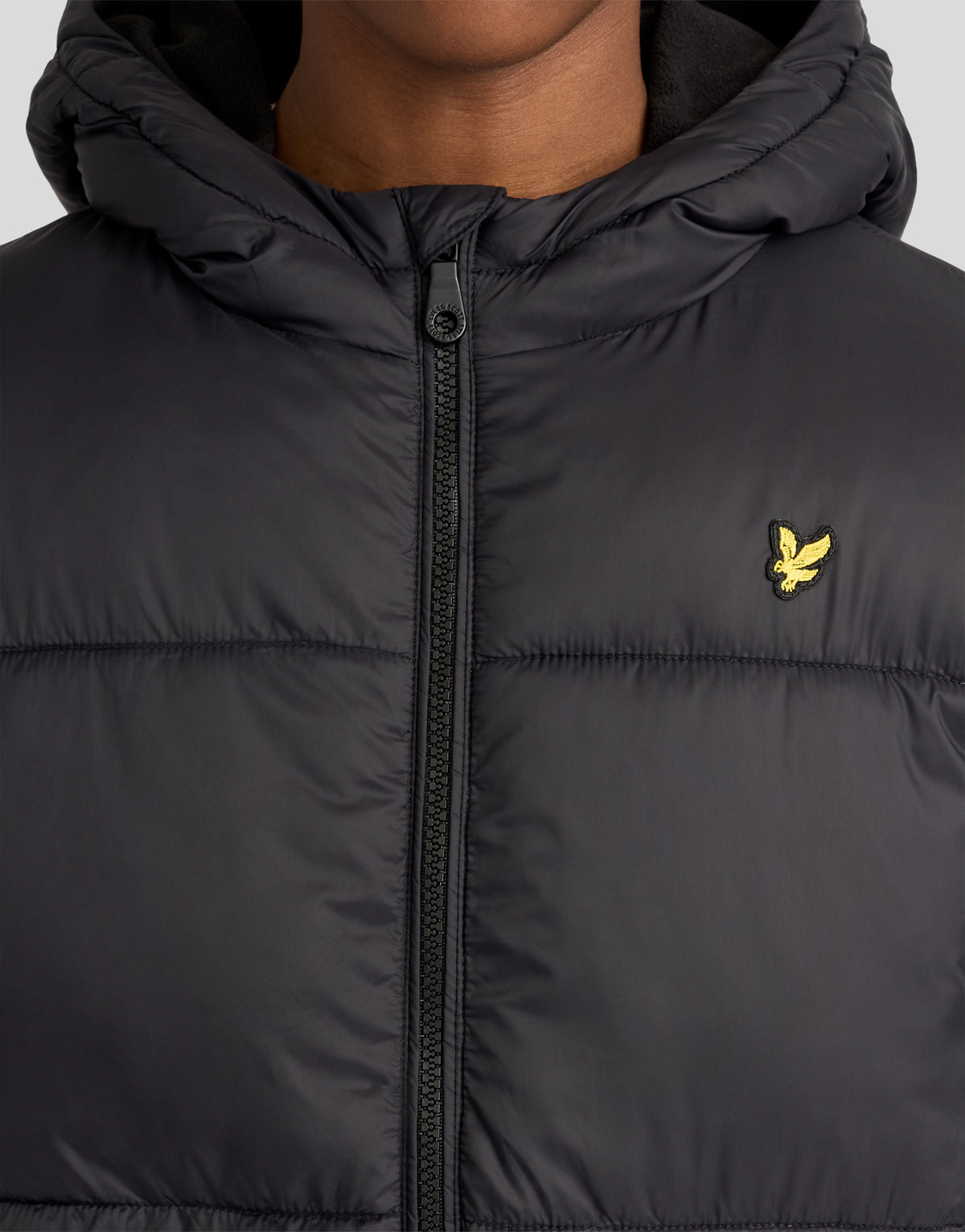 Junge in einer mit Fleece gefütterten, wattierten Jacke in Tiefschwarz