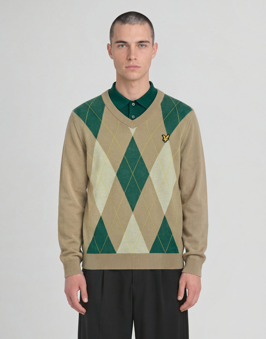 Man wears Archive Argyle Knitted V-Neck Jumper in Camel Taupe