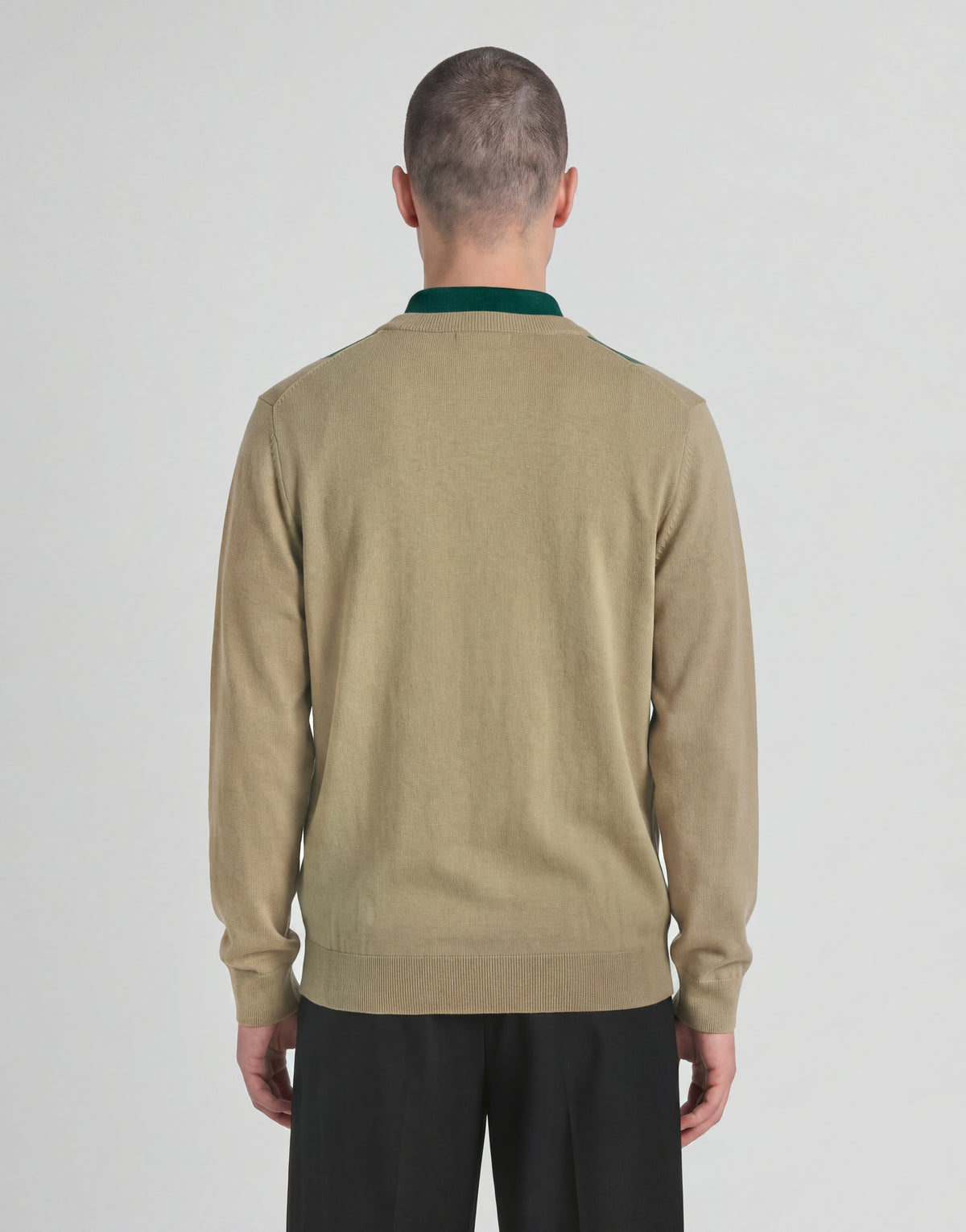 Man wears Archive Argyle Knitted V-Neck Jumper in Camel Taupe
