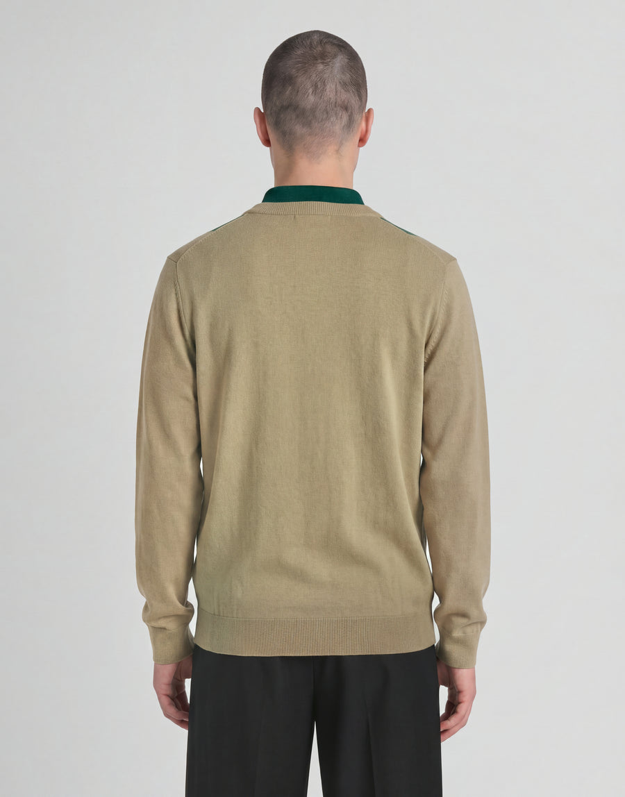 Man wears Archive Argyle Knitted V-Neck Jumper in Camel Taupe