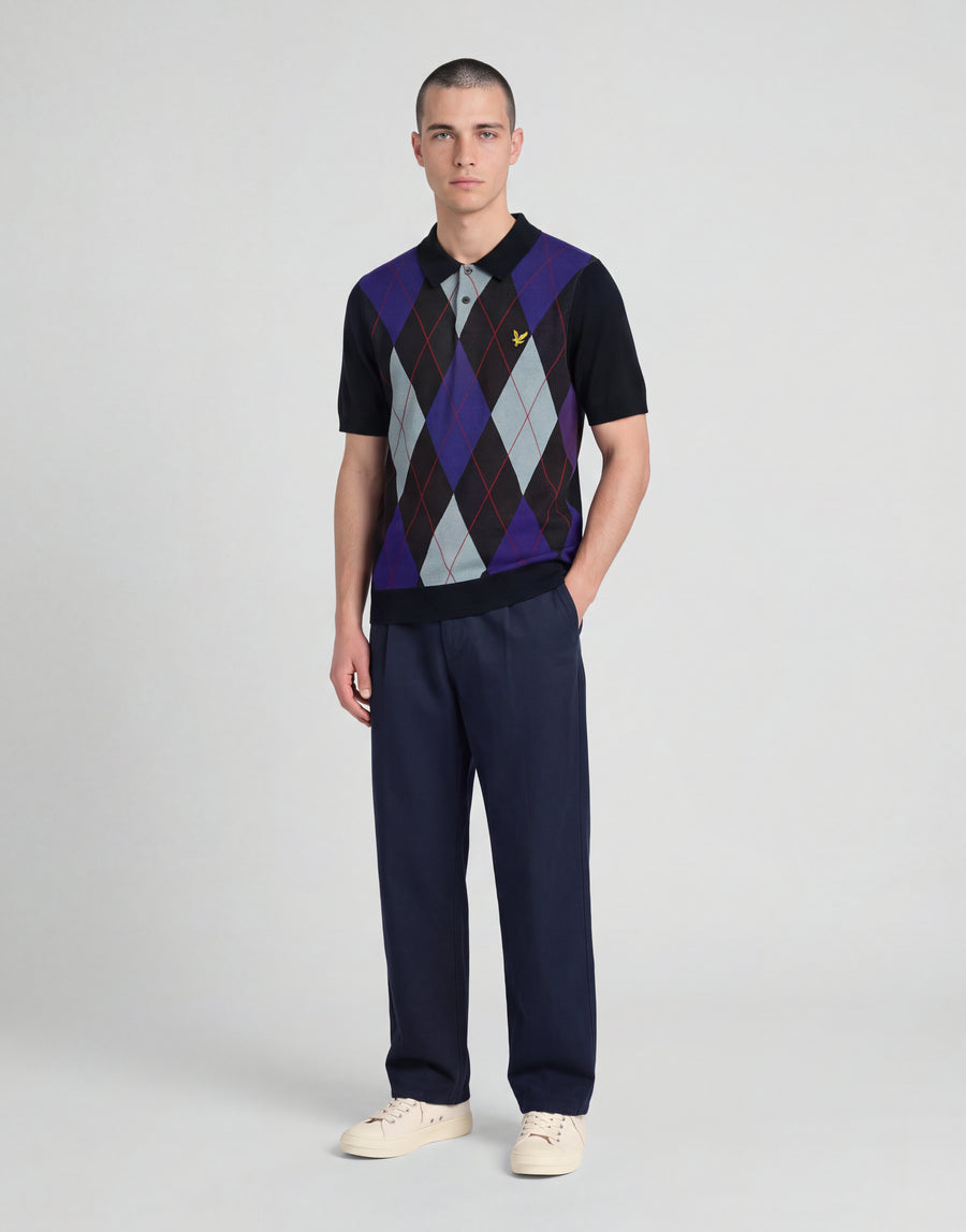 Man wears Archive Argyle Knitted Polo Shirt in Dark Navy