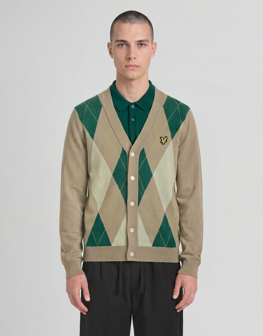Man wears Archive Argyle Knitted Cardigan in Camel Taupe