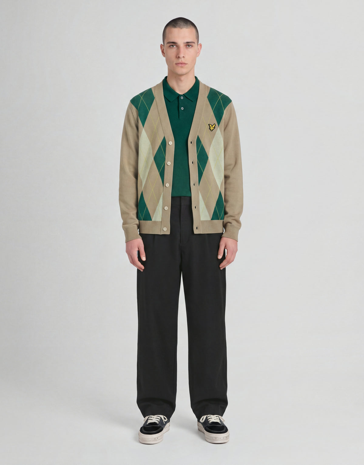 Man wears Archive Argyle Knitted Cardigan in Camel Taupe