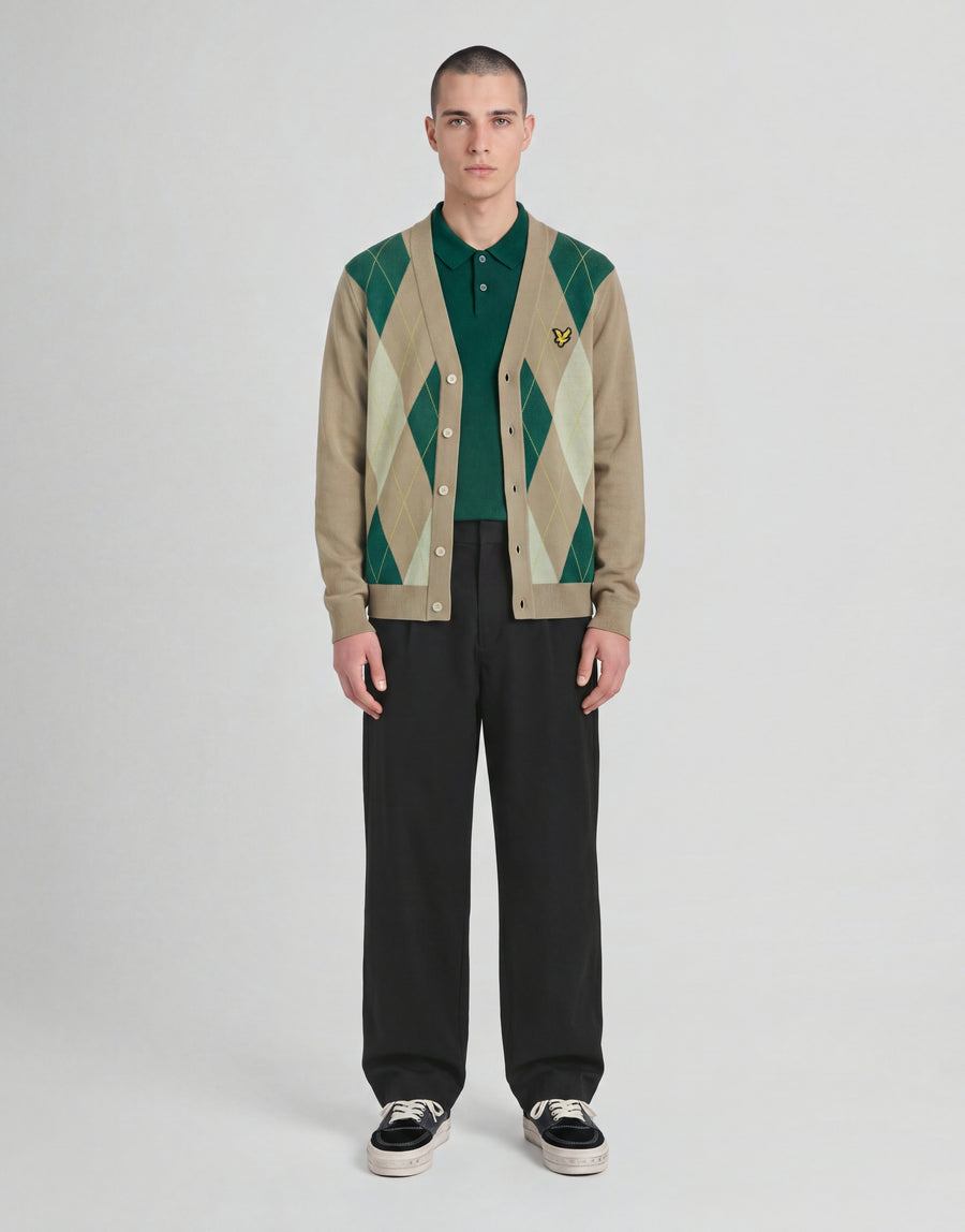 Man wears Archive Argyle Knitted Cardigan in Camel Taupe