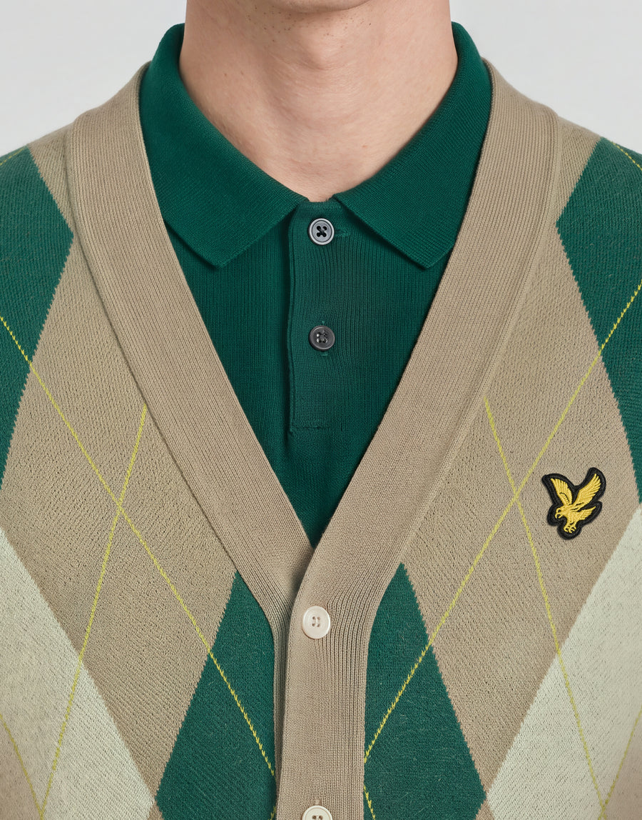 Man wears Archive Argyle Knitted Cardigan in Camel Taupe