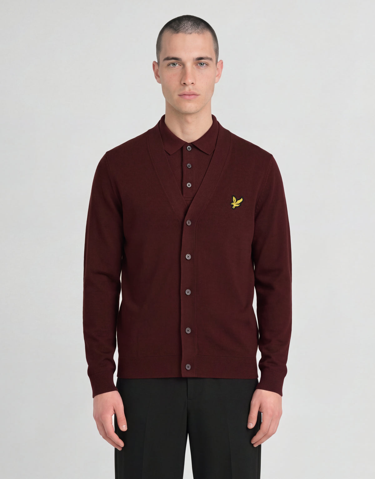 Man wears Archive Knitted Classic Cardigan in Claret Jug
