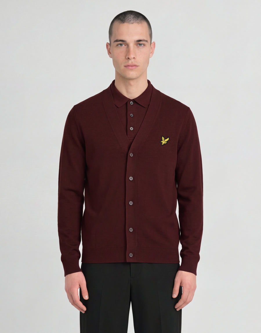 Man wears Archive Knitted Classic Cardigan in Claret Jug
