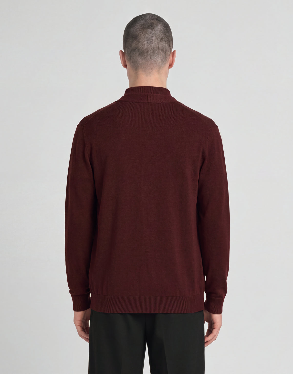 Man wears Archive Knitted Classic Cardigan in Claret Jug