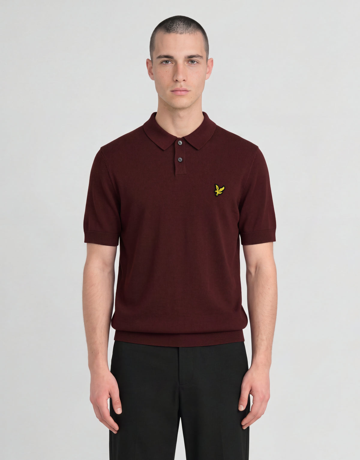 Man wears Archive Knitted Polo Shirt in Claret Jug