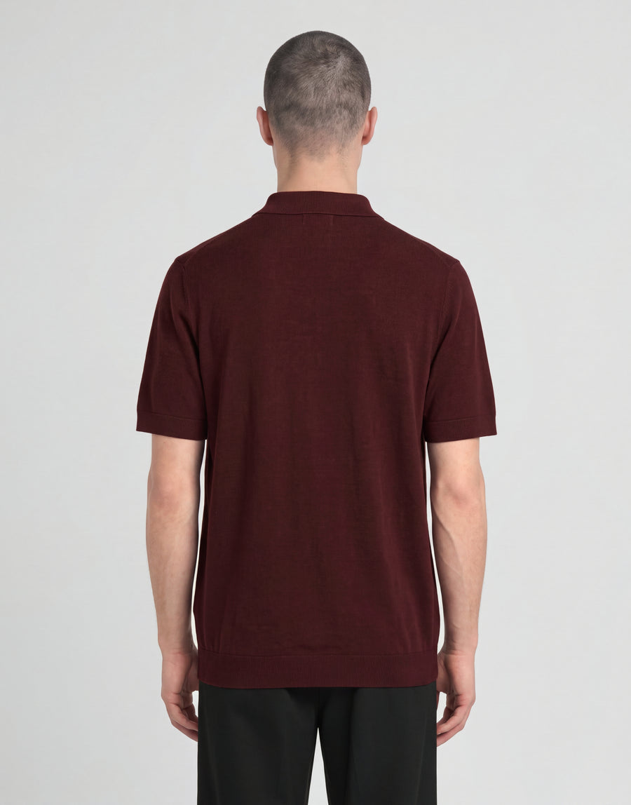 Man wears Archive Knitted Polo Shirt in Claret Jug