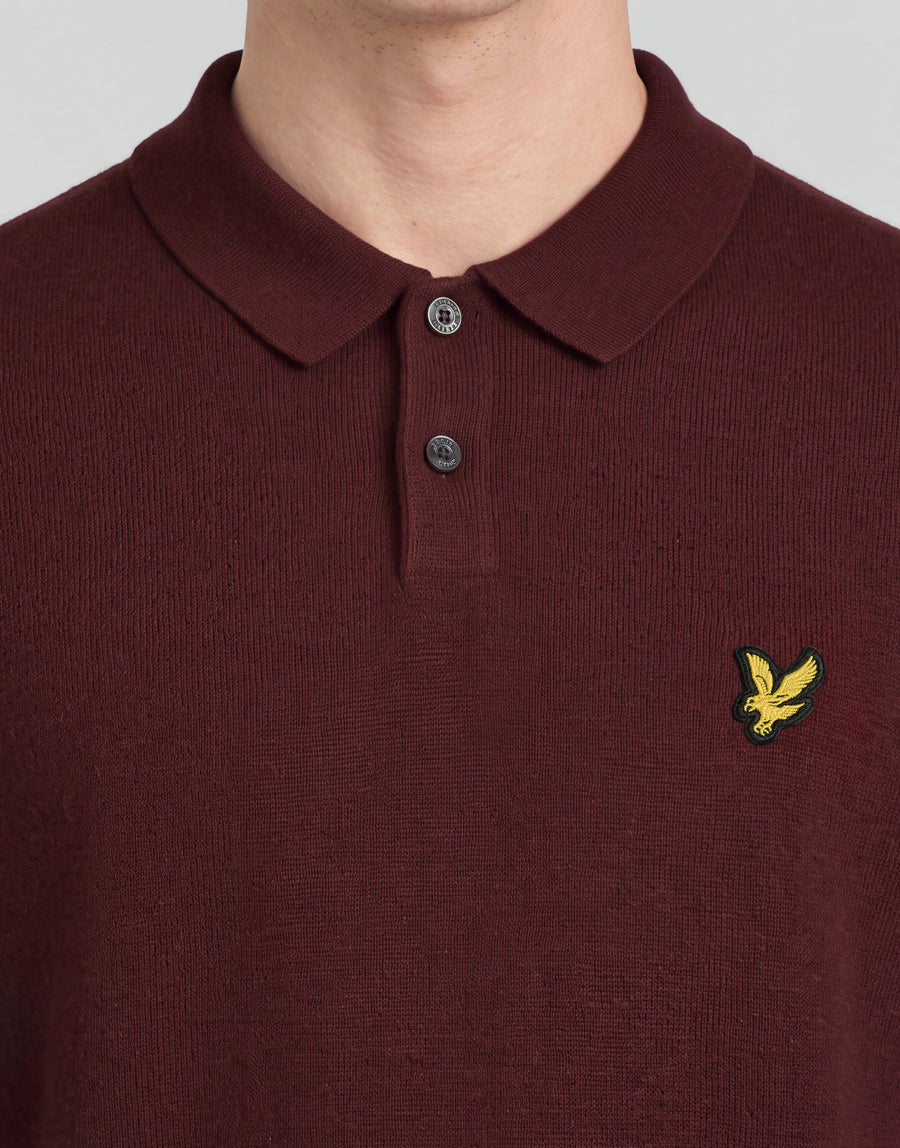 Man wears Archive Knitted Polo Shirt in Claret Jug