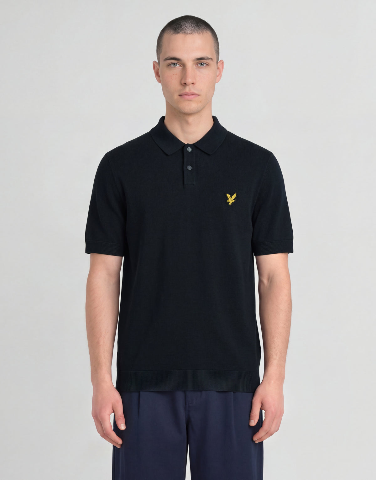 Man wears Archive Knitted Polo Shirt in Dark Navy