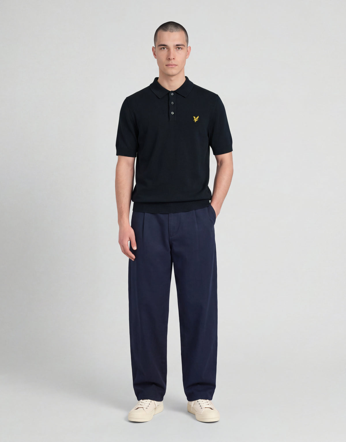 Man wears Archive Knitted Polo Shirt in Dark Navy