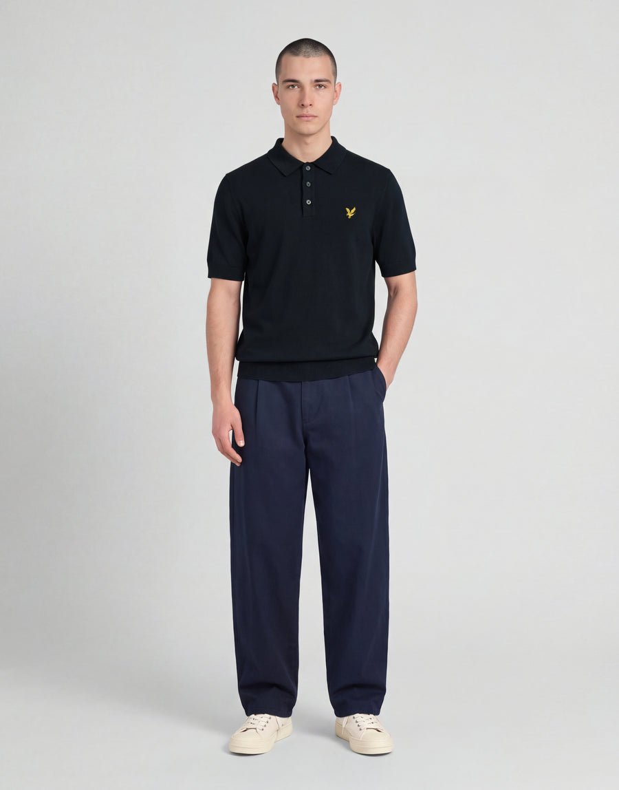 Man wears Archive Knitted Polo Shirt in Dark Navy