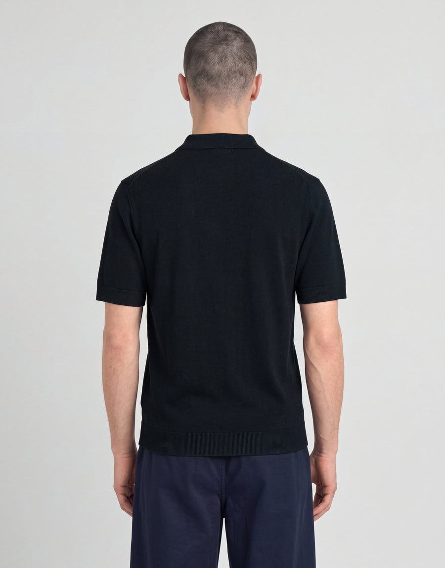 Man wears Archive Knitted Polo Shirt in Dark Navy