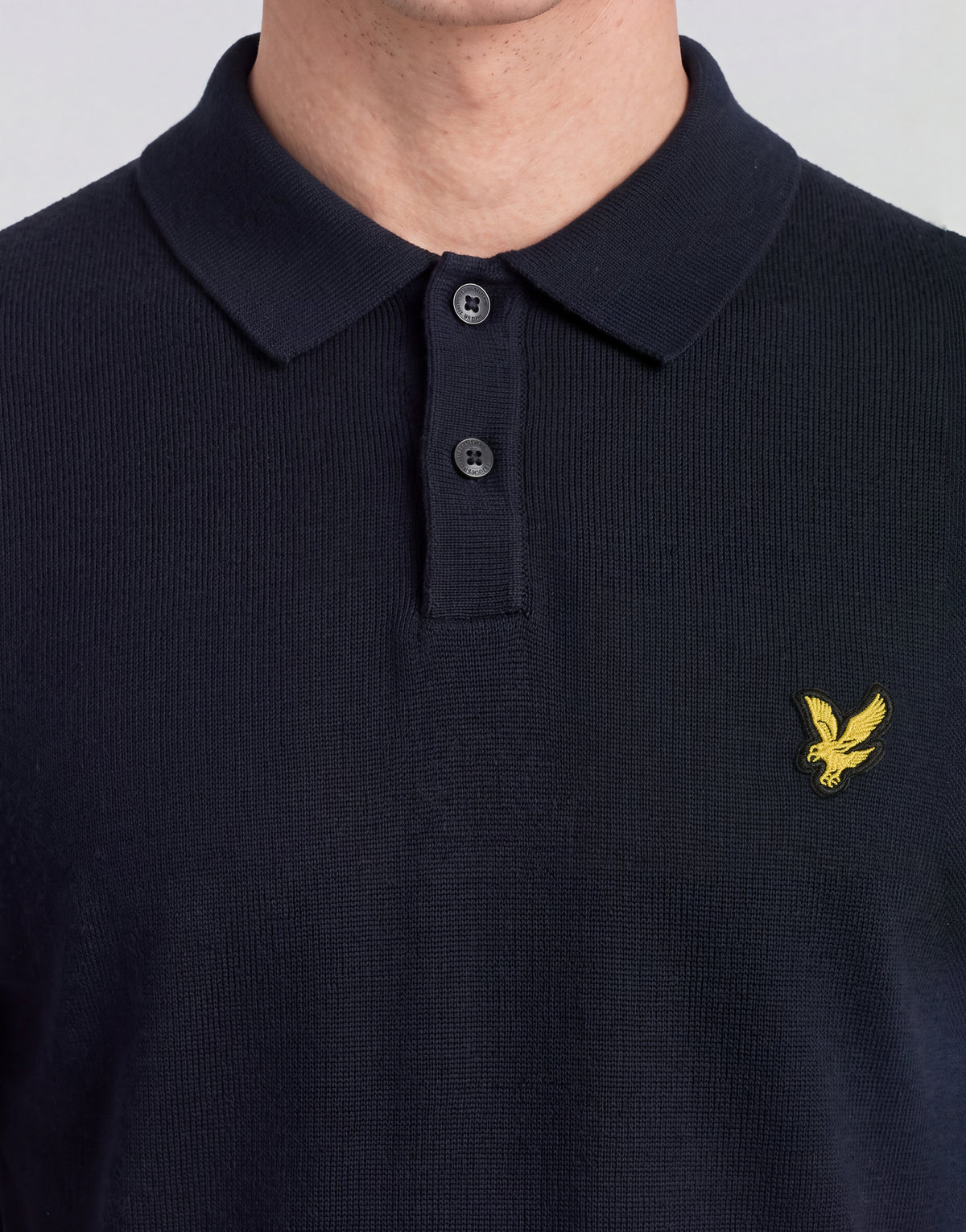 Man wears Archive Knitted Polo Shirt in Dark Navy