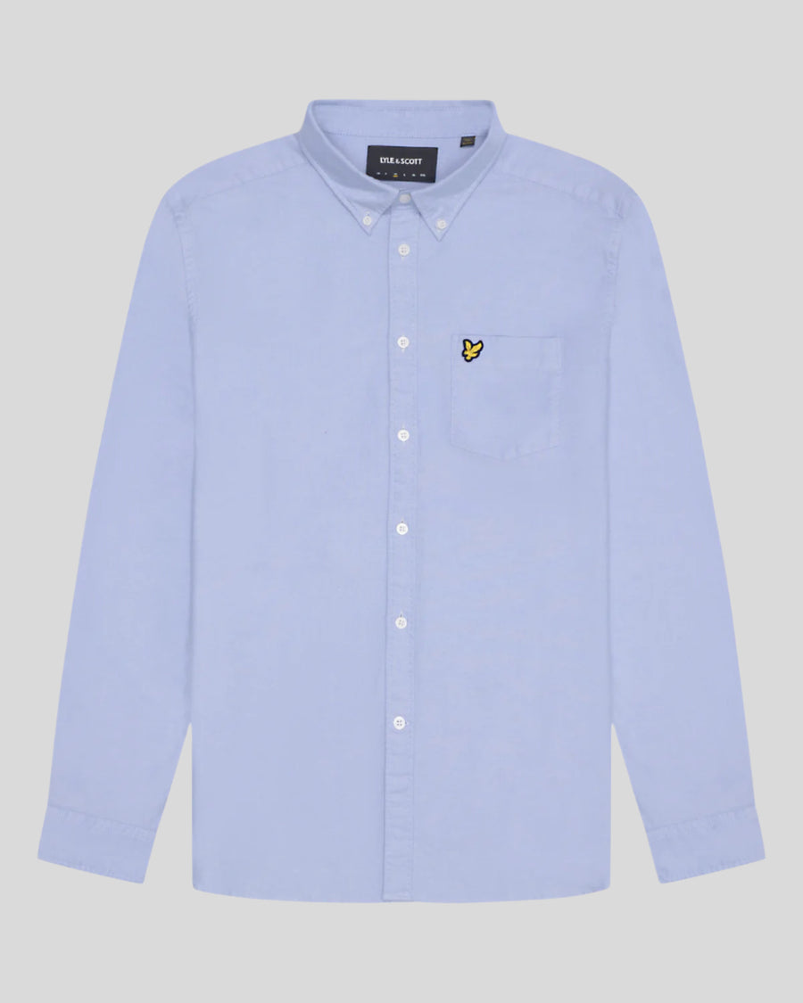 Man wears Cotton Button Down Oxford Shirt in Riviera