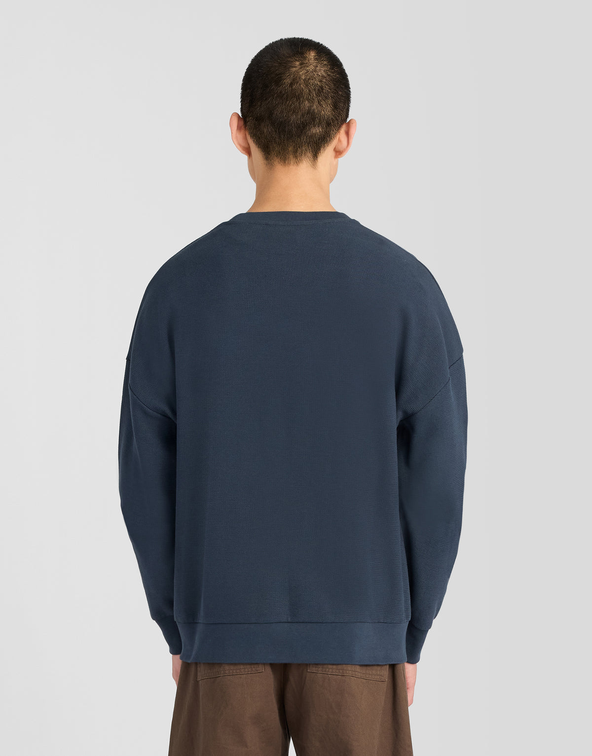Man wearing Textured Rib Crew Neck Sweatshirt in Dark Navy
