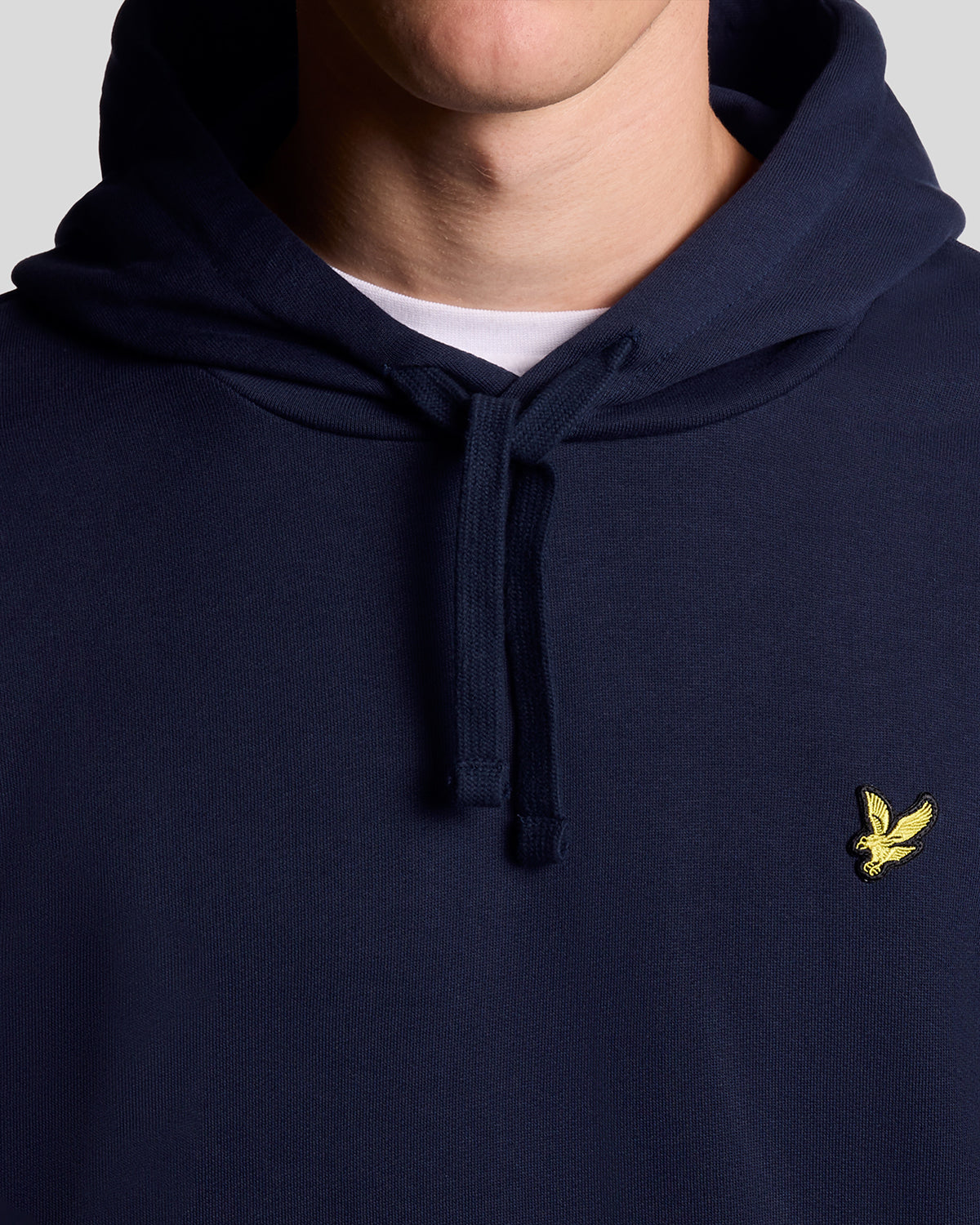 Un homme porte un sweat à capuche en coton Loopback bleu marine