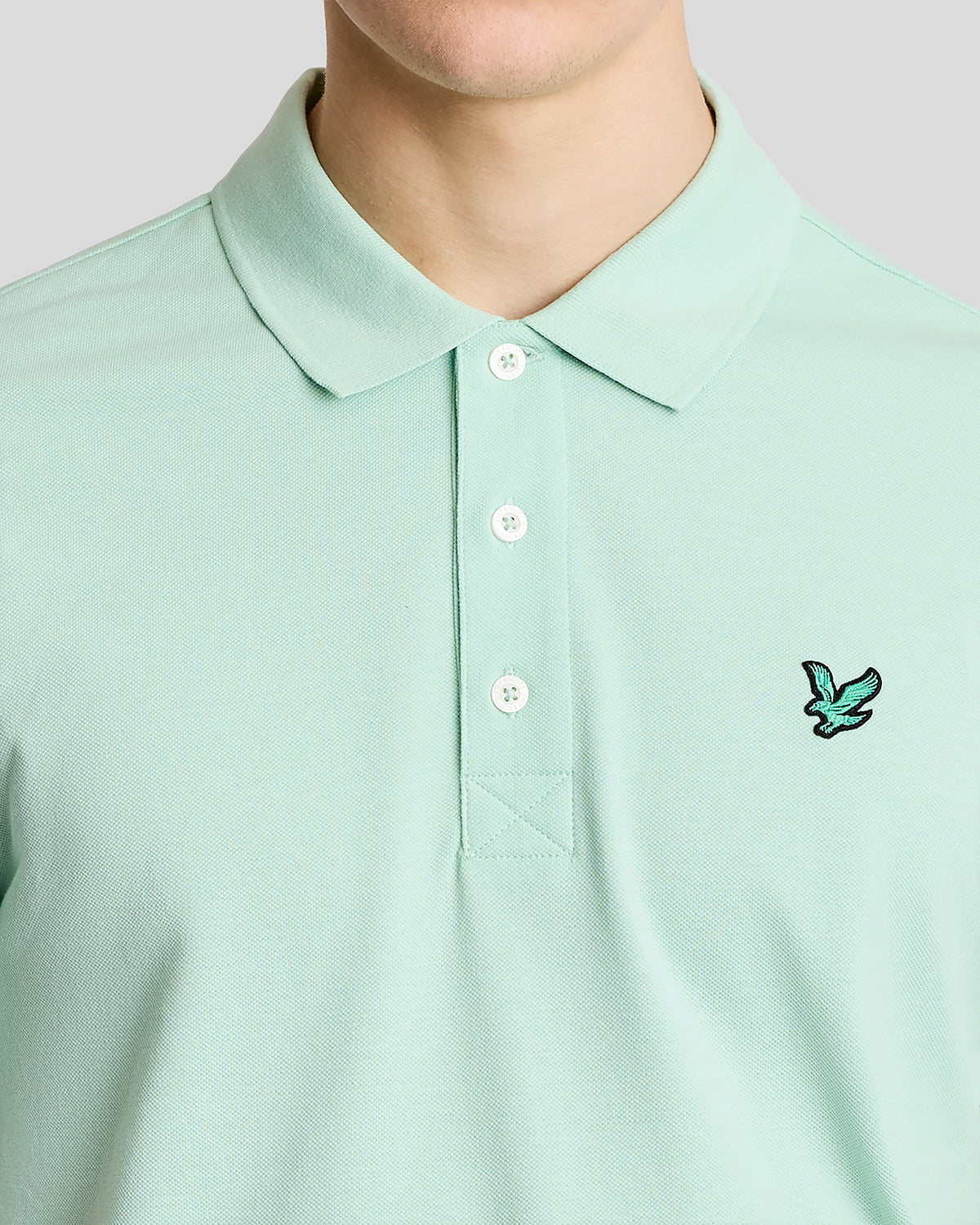 Mann trägt ein „Green Eagle“-Polohemd aus Baumwolle in der Farbe „Morning Mint“
