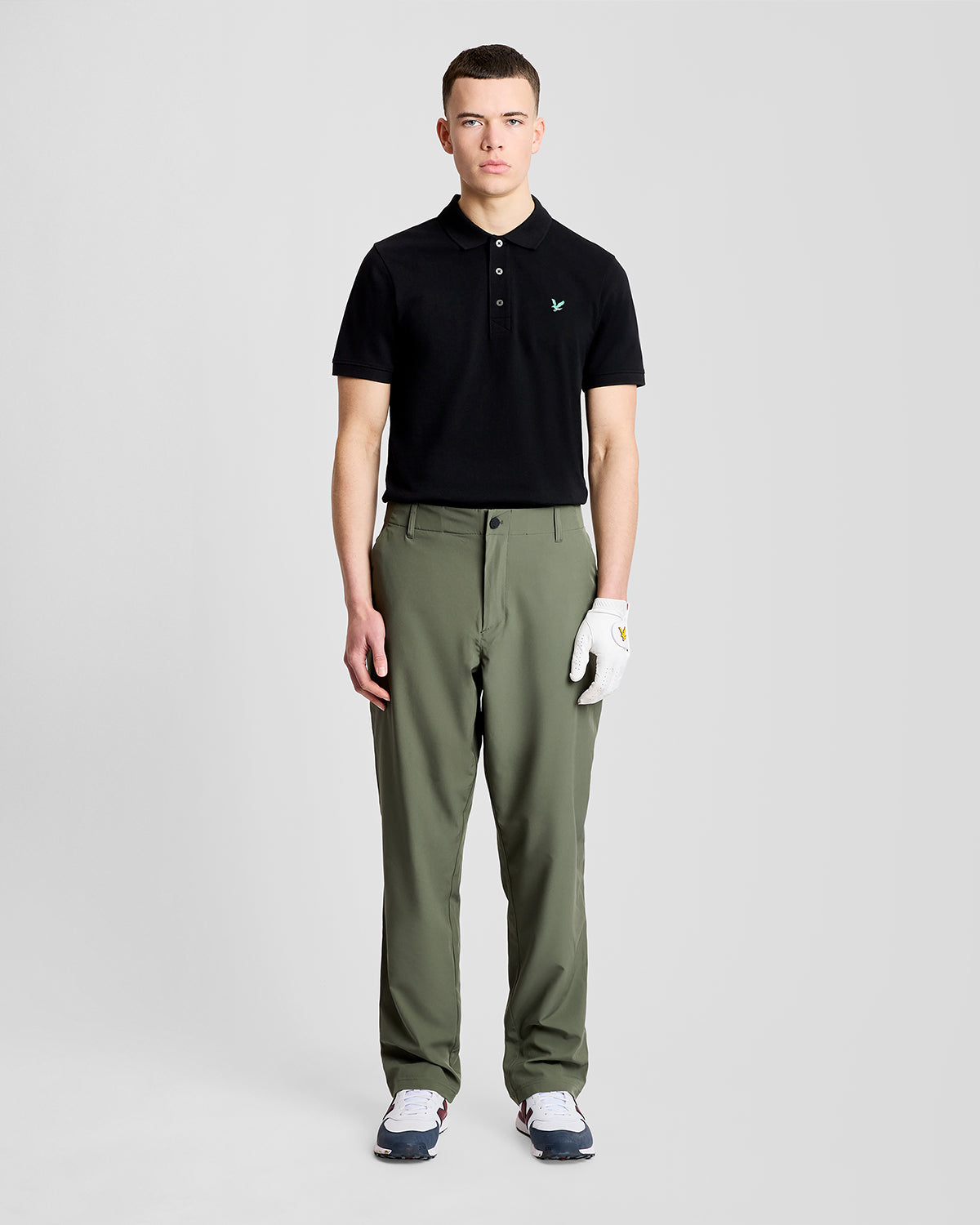 Man wears Green Eagle Cotton Polo Shirt in Jet Black