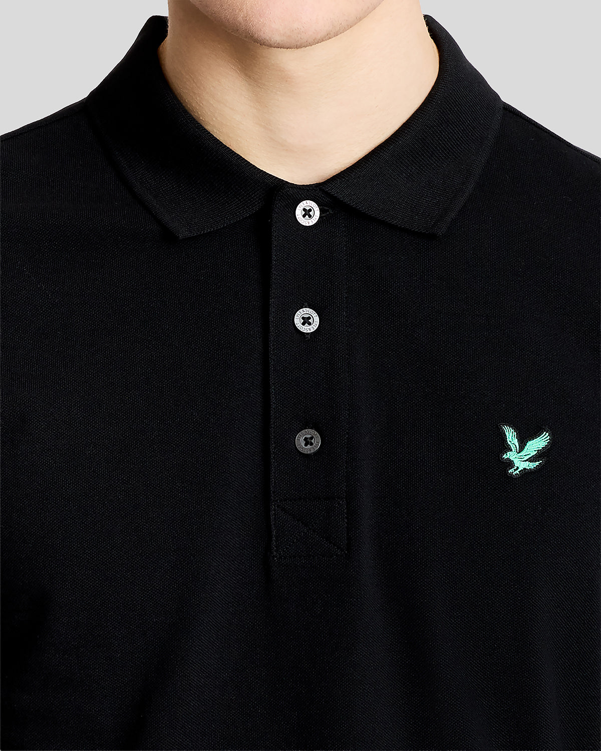 Man wears Green Eagle Cotton Polo Shirt in Jet Black