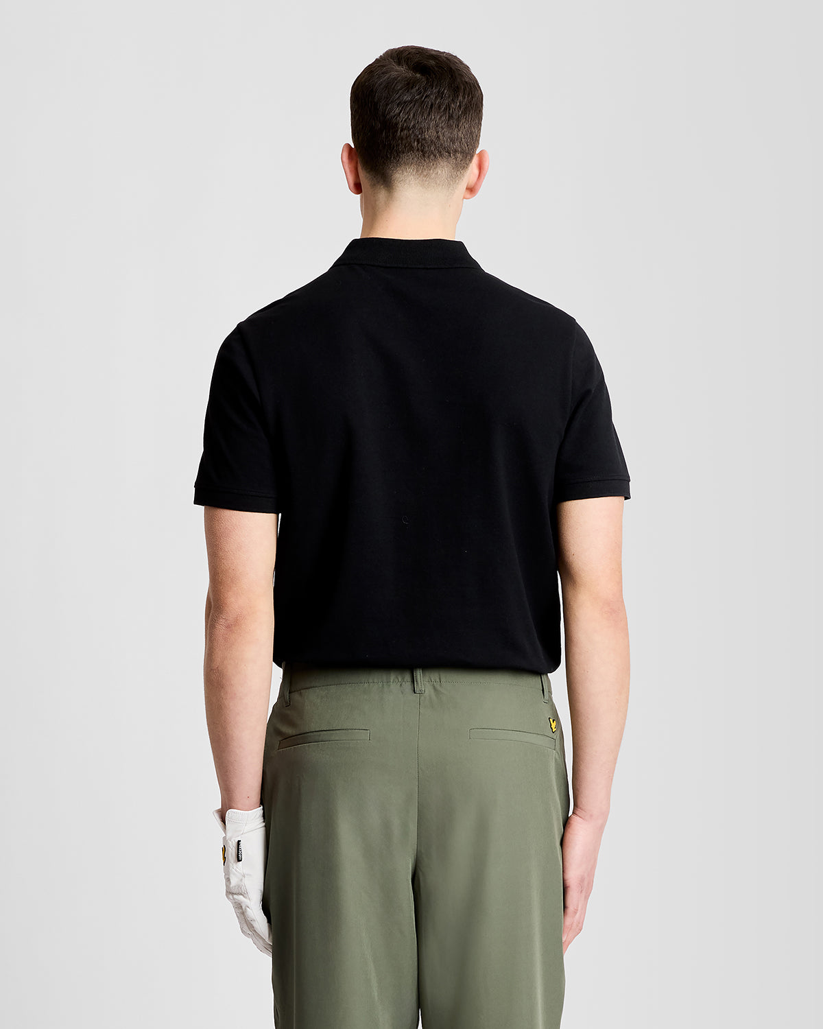 Man wears Green Eagle Cotton Polo Shirt in Jet Black