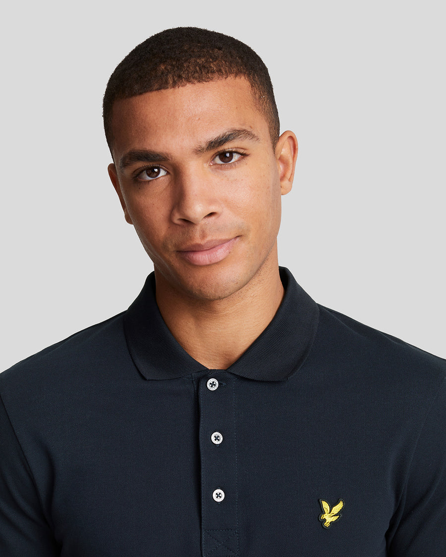 Man wears Cotton Polo Shirt in Dark Navy