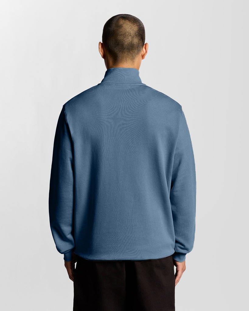 Man wears Everyday 1/4 Zip Cotton Sweatshirt in Ocean Sky