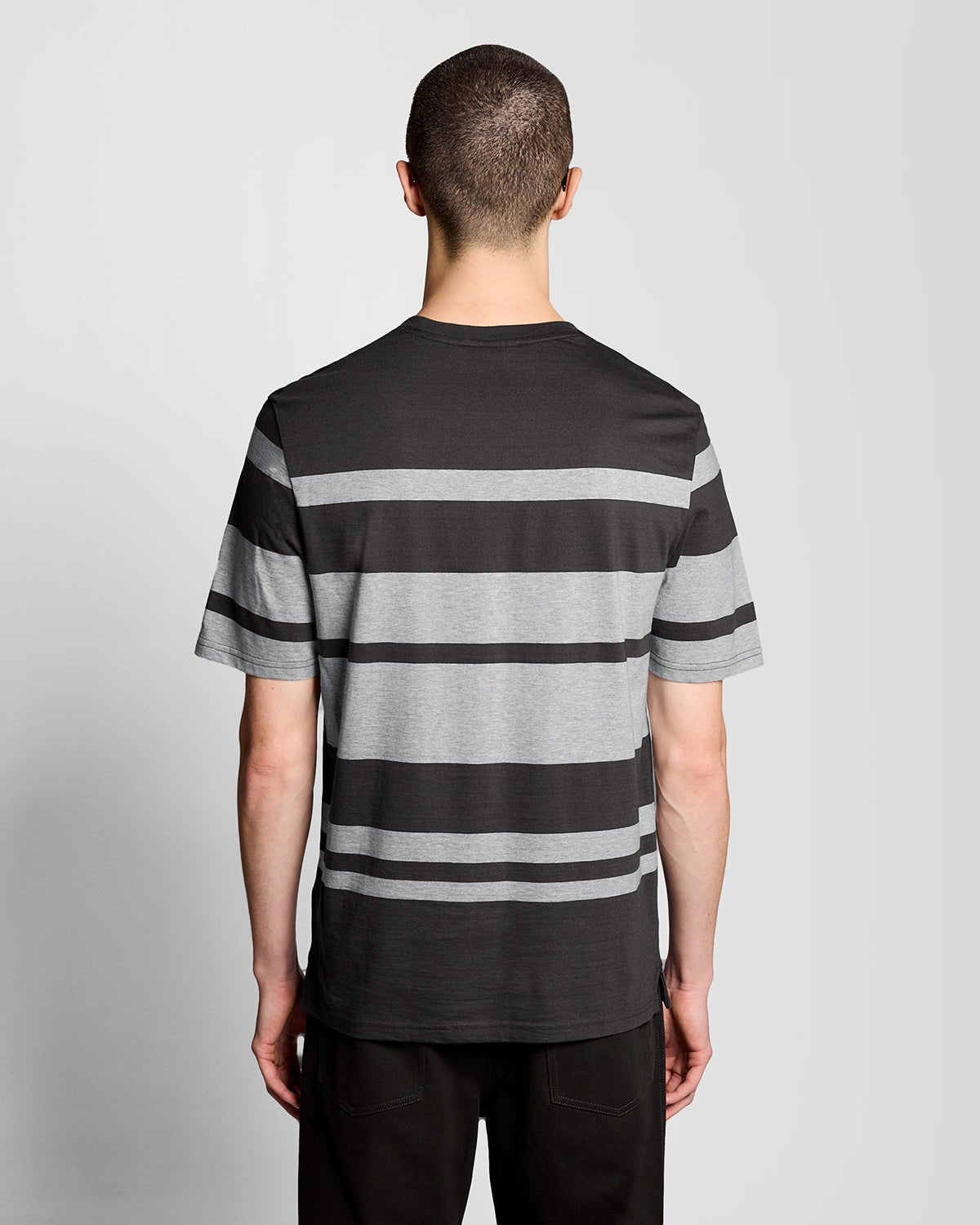 Man wears Relaxed Fit Stripe T-Shirt in Charcoal Grey/ Light Grey Marl