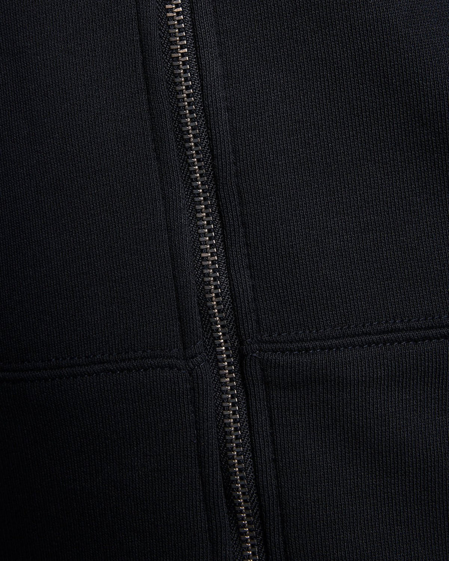Homme portant un sweat à capuche en coton Loopback à fermeture éclair intégrale, couleur bleu marine foncé