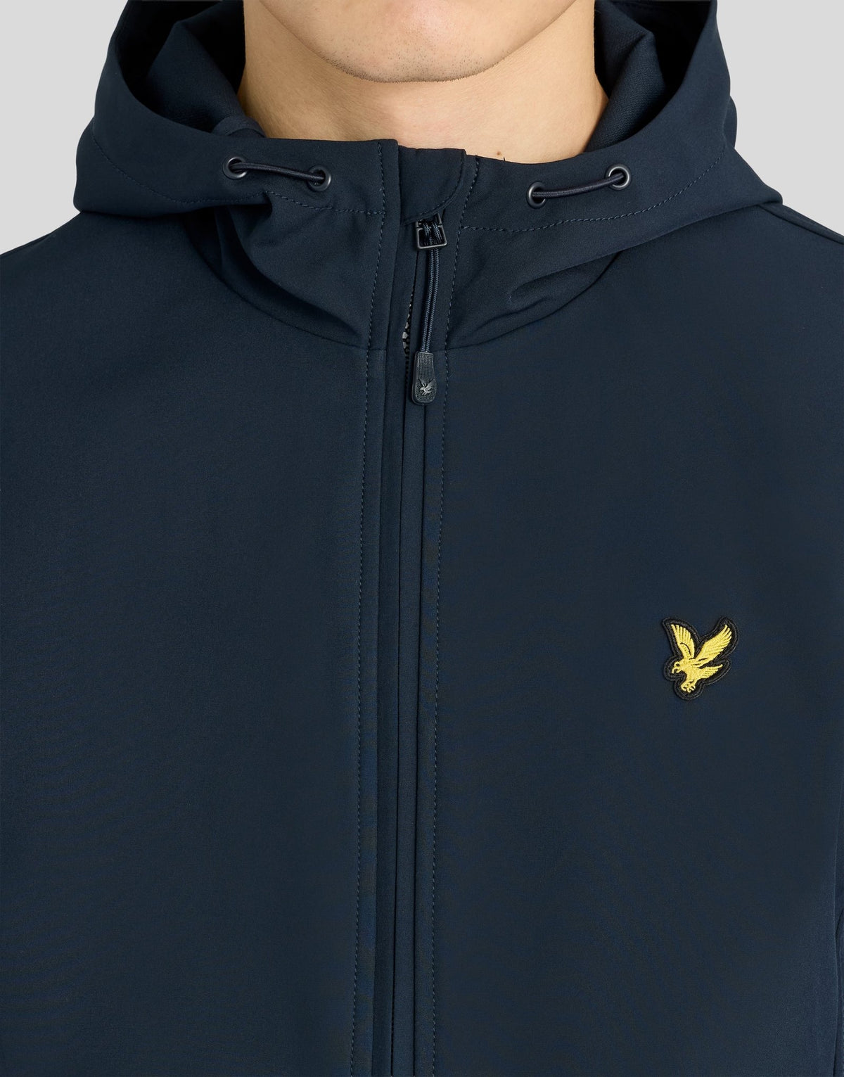 Man wears Sports Mesh-Back Softshell Jacket in Dark Navy