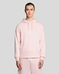 Man wears Superfine Cotton Loopback Hoodie in Light Pink
