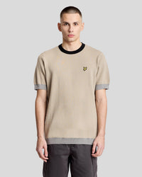 Man wears Micro Triangle Short Sleeve Jumper in Light Brown/Drizzle Grey