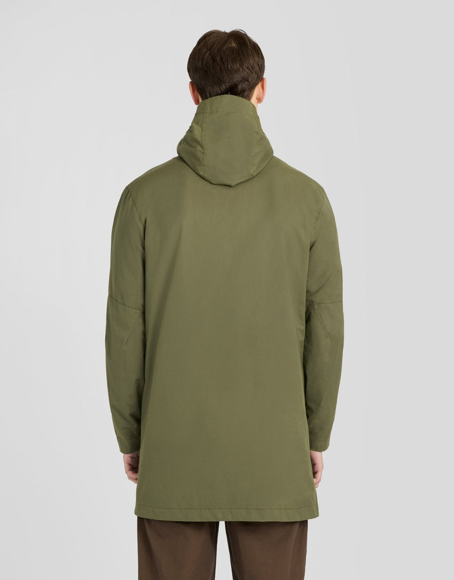 Man wears Waxed Guard Parka in True Olive