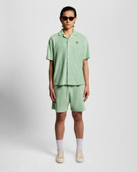 Man wears Honeycomb Effect Towelling Shorts in Misty Sage