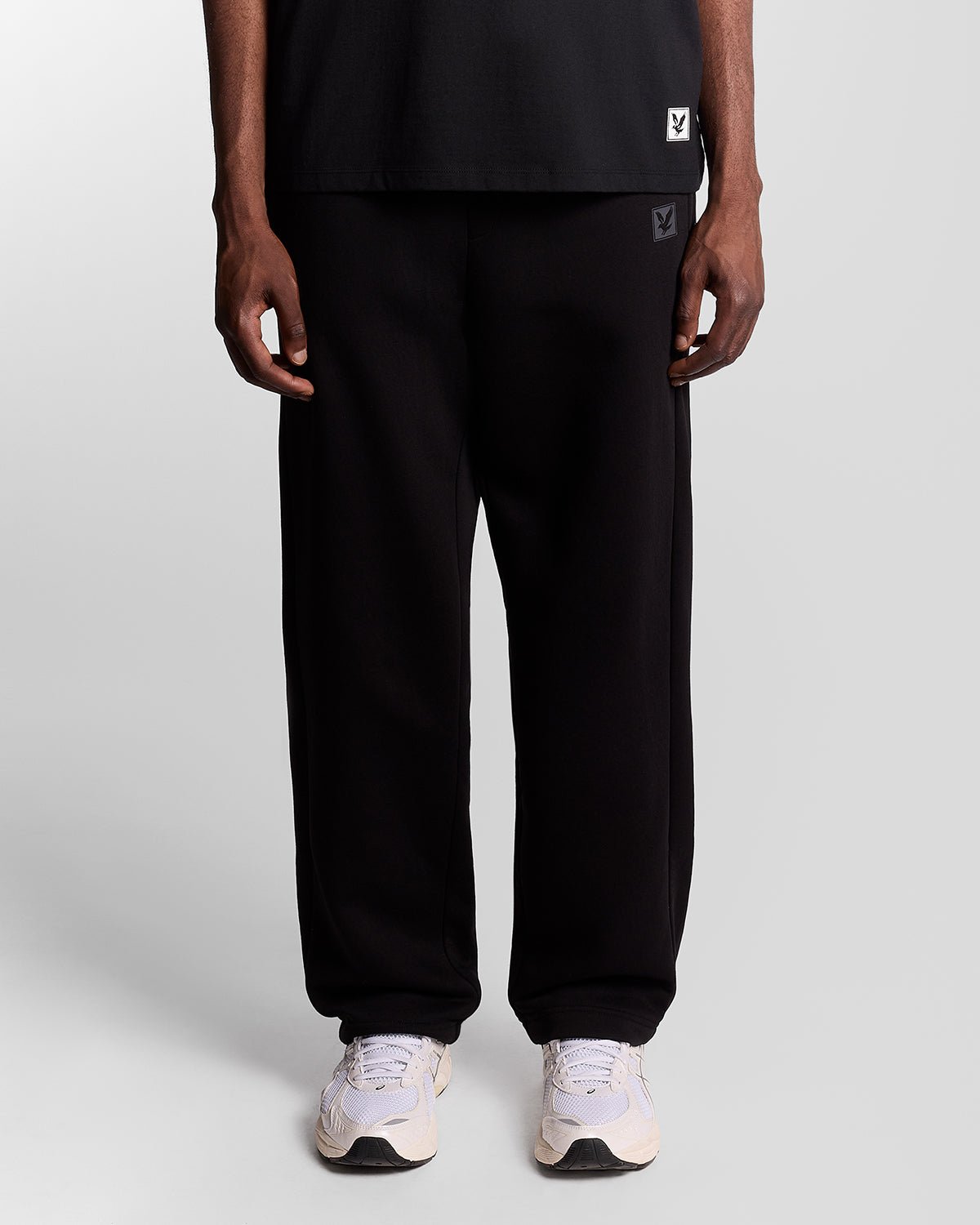 Homme portant un pantalon de jogging Lounge à coupe droite, couleur noir de jais