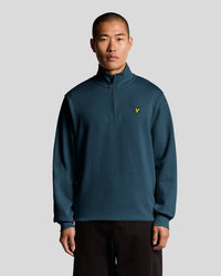 Man wears Everyday 1/4 Zip Cotton Sweatshirt in Rich Teal