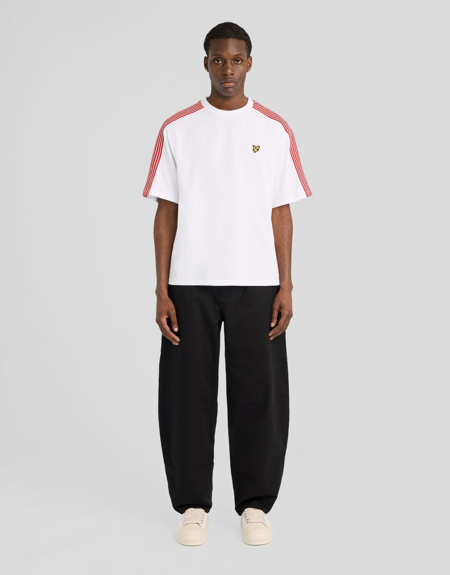 Man wears Stripe Taped Cotton T-Shirt in White