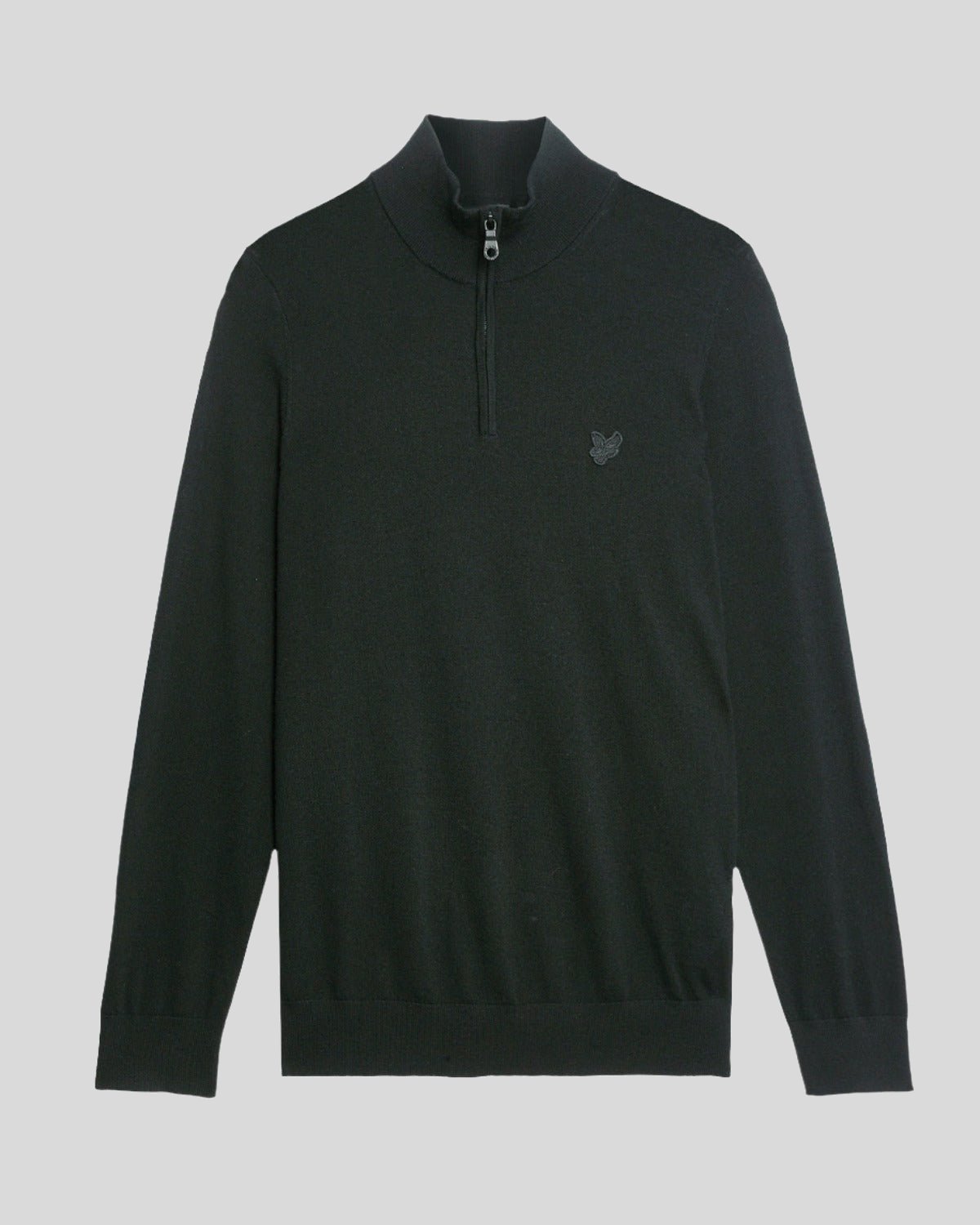 Man wears Merino Wool 1/4 Zip Jumper in Jet Black