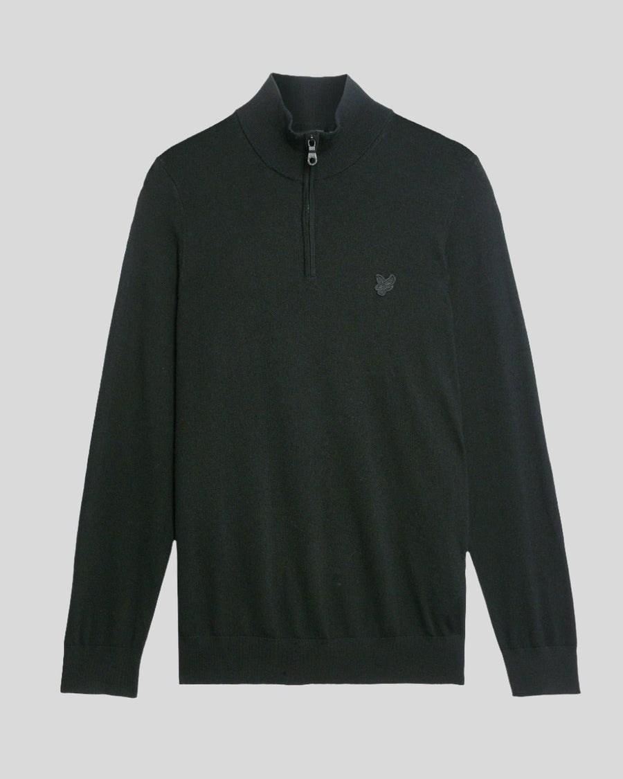 Man wears Merino Wool 1/4 Zip Jumper in Jet Black