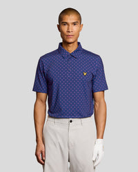Man wears Cross Print Polo Shirt in Navy Peony