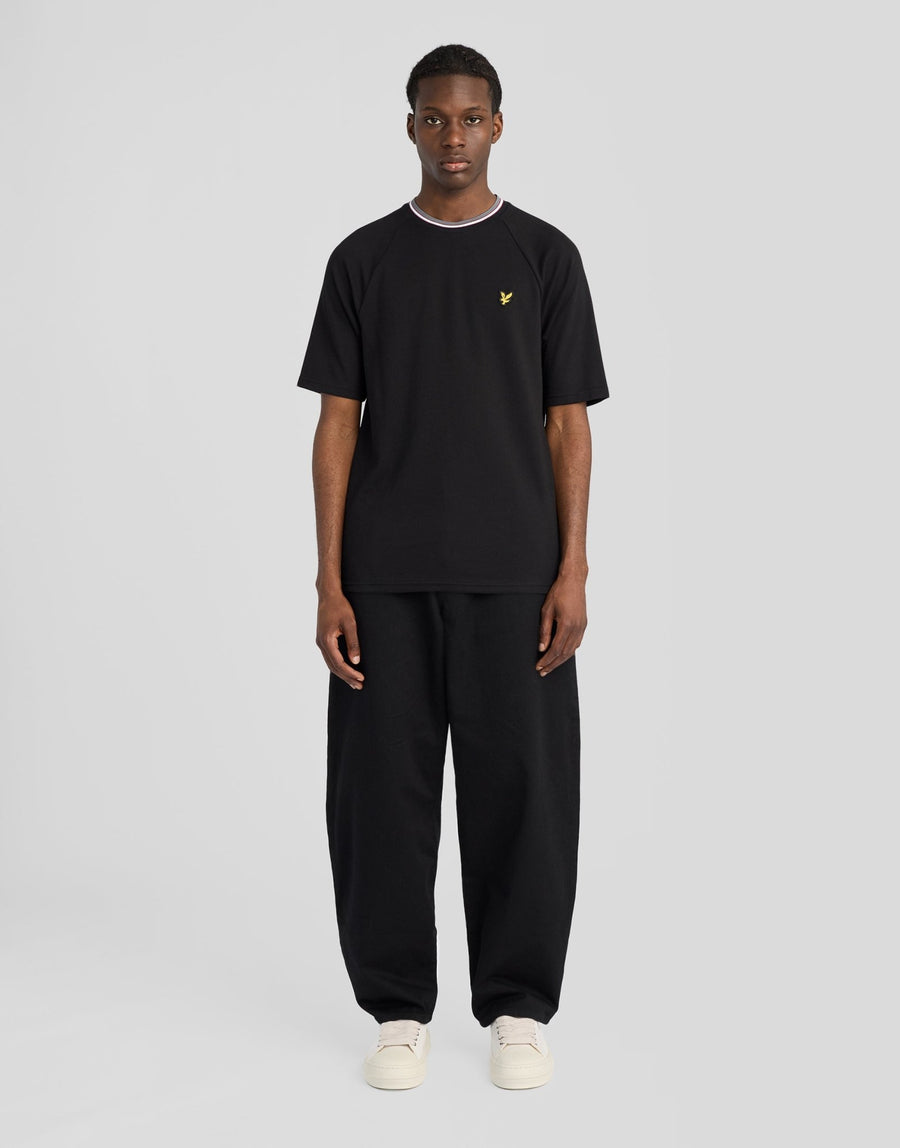 Man wears Tipped Track T-Shirt in Jet Black