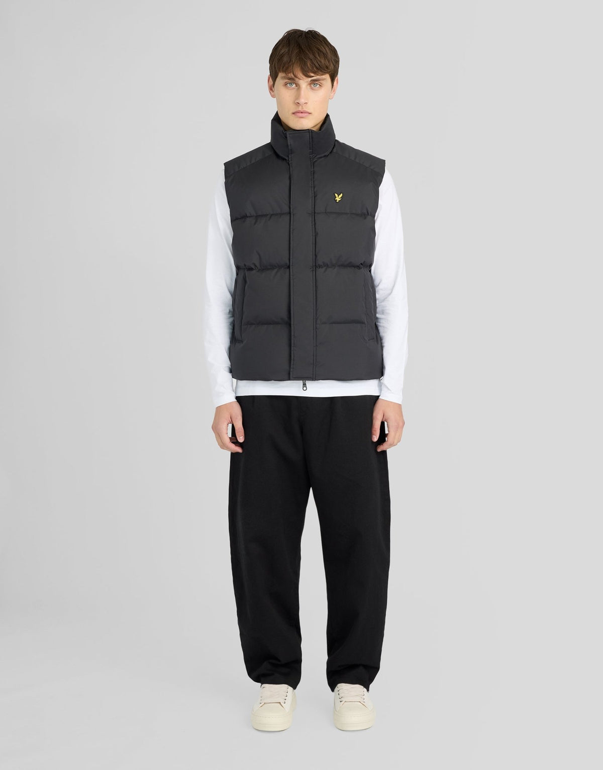 Man wears Funnel Neck Puffer Gilet in Jet Black