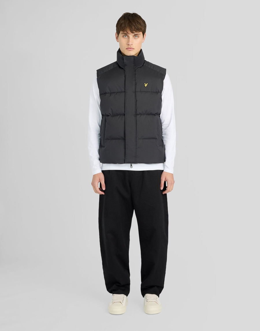 Man wears Funnel Neck Puffer Gilet in Jet Black